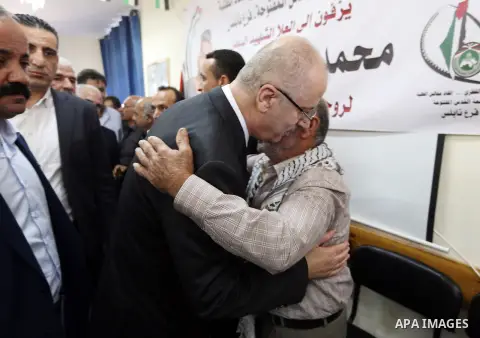 Palestinian Prime Minister Rami Hamdallah offers condolences for the family of Mohammed Basharat, who was shot dead by Israeli forces last Wednesday, in the village of Taamun near the West Bank city of Tubas, on October...