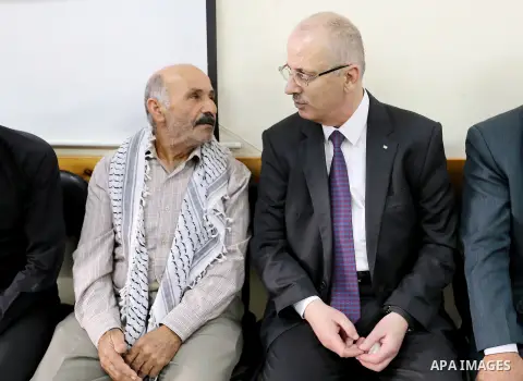 Palestinian Prime Minister Rami Hamdallah offers condolences for the family of Mohammed Basharat, who was shot dead by Israeli forces last Wednesday, in the village of Taamun near the West Bank city of Tubas, on October...