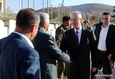 Palestinian Prime Minister Rami Hamdallah offers condolences for the family of Mohammed Basharat, who was shot dead by Israeli forces last Wednesday, in the village of Taamun near the West Bank city of Tubas, on October...
