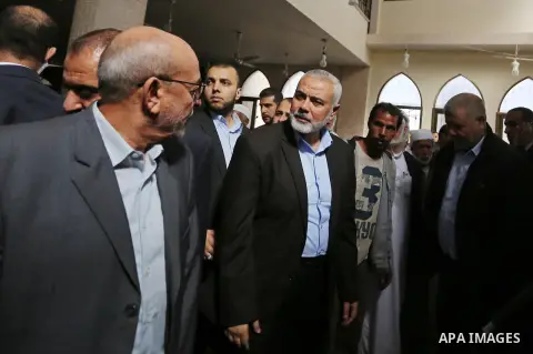 Palestinian Hamas Chief Ismail Haniyeh attends the funeral of three Palestinian teenagers who were killed in an Israeli air strike on the Gaza Strip during their funeral in Deir el-Balah in central of the Gaza Strip on O...
