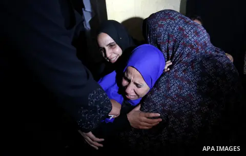 Relatives of Palestinian teenager Khaled Saed, who was killed in an Israeli air strike on the Gaza Strip , mourn during his funeral in Deir el-Balah in central of the Gaza Strip on October 29, 2018. Photo by Ashraf Amra
