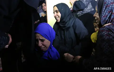 Relatives of Palestinian teenager Khaled Saed, who was killed in an Israeli air strike on the Gaza Strip , mourn during his funeral in Deir el-Balah in central of the Gaza Strip on October 29, 2018. Photo by Ashraf Amra