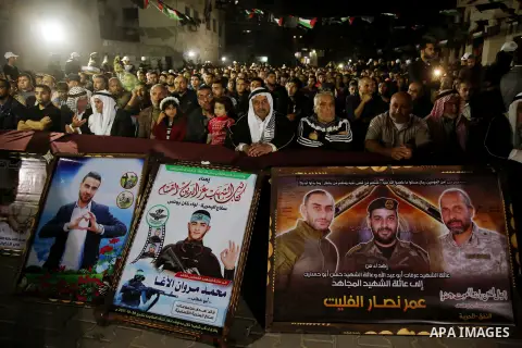 Palestinian supporters of Islamic Jihad movement attends a memorial service for Islamic Jihad militants who were killed in an Israeli operation to blow up a tunnel last year, at the Bureij refugee camp, in central Gaza S...