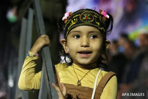 Palestinian supporters of Islamic Jihad movement attends a memorial service for Islamic Jihad militants who were killed in an Israeli operation to blow up a tunnel last year, at the Bureij refugee camp, in central Gaza S...