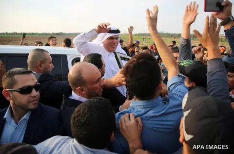 Qatar's Ambassador to the Palestinian Authority, Mohammed Al Emadi, waves to Palestinian protesters during tents protest where Palestinians demand the right to return to their homeland at the Israel-Gaza border, in east...