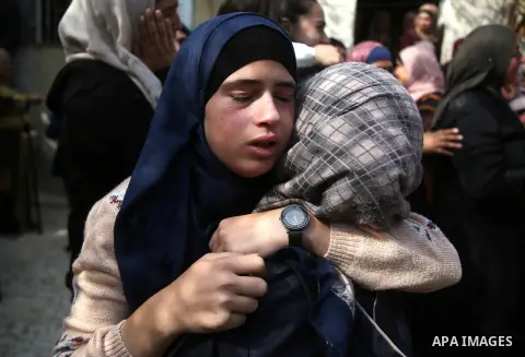 Relaitves of Palestinian Mohammed Shreteh who was dead of his wounds that were sustained during clashes with Israeli soldiers last month, mourn during his funeral in the West Bank village of Mazraa al-Gharbiya, near Rama...