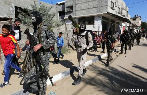 Palestinian militants of the Al-Nasser Saladin Brigades take part in the funeral of Palestinian Khaled Qwaider one of the seven Palestinians killed during an Israeli special forces operation in the Gaza Strip, in Khan Yo...