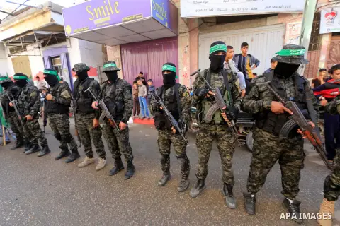Palestinian militants of the Islamist movement Hamas' military wing Al-Qassam Brigades, attend the funeral of Mustafa Abu Odeh and Mahmoud Atallah, two of the seven Palestinians killed during an Israeli special forces op...