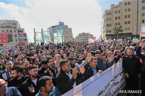 Palestinians take part during a protest against a social security law in the West Bank city of Ramallah on November 12, 2018. Photo by Shadi Hatem