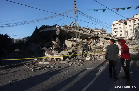 Palestinians look at the rubble of a building in Gaza City on November 13, 2018, after an Israeli air strike. Renewed violence in Gaza threatened to thwart efforts to end months of unrest as Israeli air strikes killed fo...