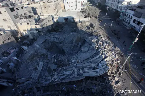 Palestinians look at the rubble of a building in Gaza City on November 13, 2018, after an Israeli air strike. Renewed violence in Gaza threatened to thwart efforts to end months of unrest as Israeli air strikes killed fo...