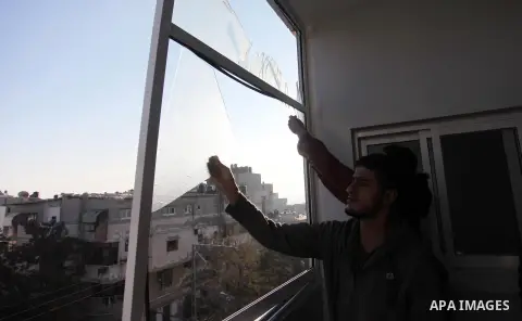 Palestinians look at the rubble of a building in Gaza City on November 13, 2018, after an Israeli air strike. Renewed violence in Gaza threatened to thwart efforts to end months of unrest as Israeli air strikes killed fo...