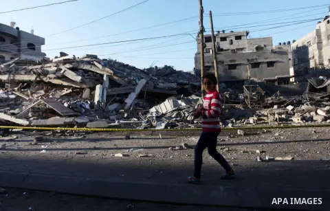Palestinians look at the rubble of a building in Gaza City on November 13, 2018, after an Israeli air strike. Renewed violence in Gaza threatened to thwart efforts to end months of unrest as Israeli air strikes killed fo...