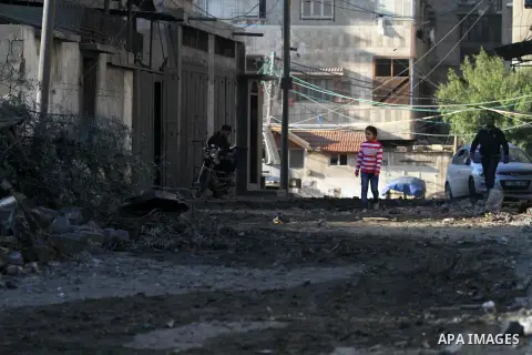 Palestinians look at the rubble of a building in Gaza City on November 13, 2018, after an Israeli air strike. Renewed violence in Gaza threatened to thwart efforts to end months of unrest as Israeli air strikes killed fo...