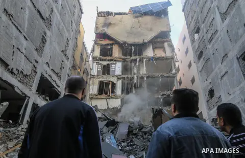 Palestinians look at the rubble of a building after an Israeli air strike in Gaza City on November 13, 2018. Renewed violence in Gaza threatened to thwart efforts to end months of unrest as Israeli air strikes killed fou...