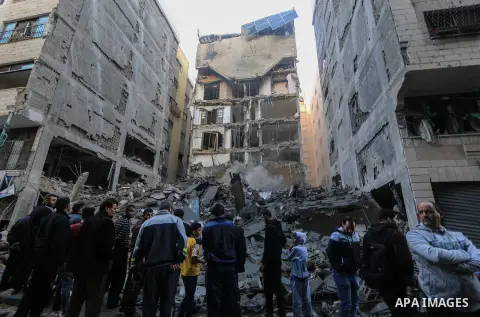 Palestinians look at the rubble of a building after an Israeli air strike in Gaza City on November 13, 2018. Renewed violence in Gaza threatened to thwart efforts to end months of unrest as Israeli air strikes killed fou...