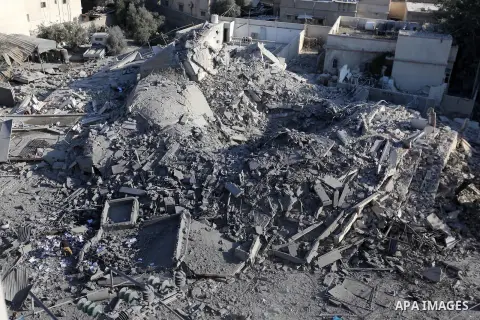 Palestinians look at the rubble of a building after an Israeli air strike in Gaza City on November 13, 2018. Renewed violence in Gaza threatened to thwart efforts to end months of unrest as Israeli air strikes killed fou...