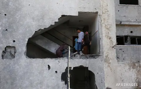 Palestinians look at the rubble of the television station al-Aqsa TV after an Israeli air strike in Gaza City on November 13, 2018, . Renewed violence in Gaza threatened to thwart efforts to end months of unrest as Israe...
