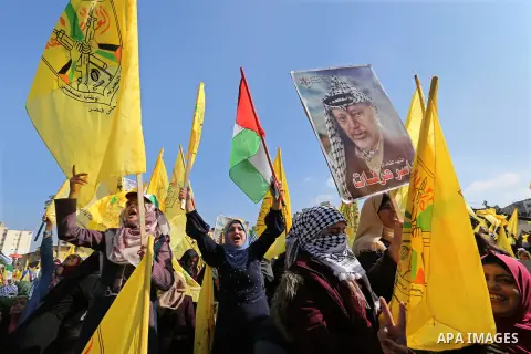 Palestinian Fatah supporters take part in a rally to mark the 14th anniversary of the death of late Palestinian leader Yasser Arafat in Gaza City on November 20, 2018. Photo by Ashraf Amra