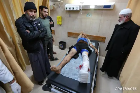 A Palestinian protester who was wounded by Israeli forces during tents protest where Palestinians demand the right to return to their homeland at the Israel-Gaza border, recives treatment at a hospital in Deir al-Balah i...
