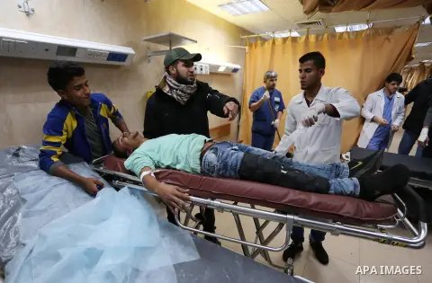 A Palestinian protester who was wounded by Israeli forces during tents protest where Palestinians demand the right to return to their homeland at the Israel-Gaza border, recives treatment at a hospital in Deir al-Balah i...