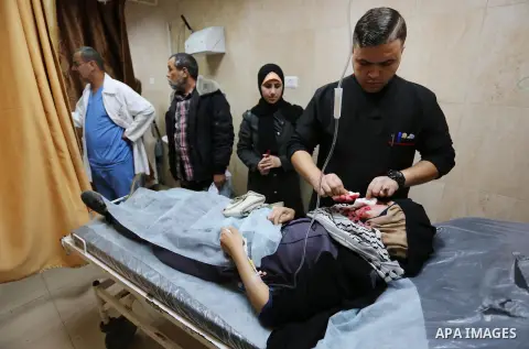A Palestinian protester who was wounded by Israeli forces during tents protest where Palestinians demand the right to return to their homeland at the Israel-Gaza border, recives treatment at a hospital in Deir al-Balah i...