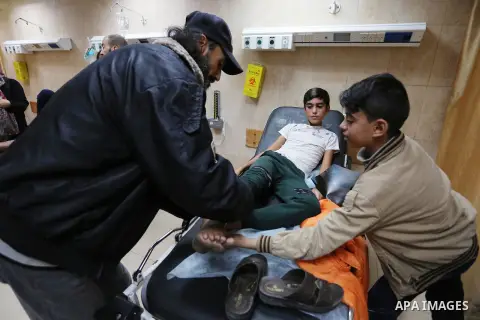 A Palestinian protester who was wounded by Israeli forces during tents protest where Palestinians demand the right to return to their homeland at the Israel-Gaza border, recives treatment at a hospital in Deir al-Balah i...