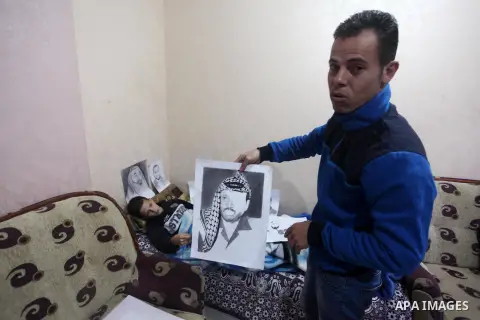 The father of Palestinian painter Majd al-Madhoun, 13, who was wounded by Israeli army in the head on November 19, during a demonstration against the Israeli blockade on Gaza Strip, along the Gaza sea barrier on the mari...