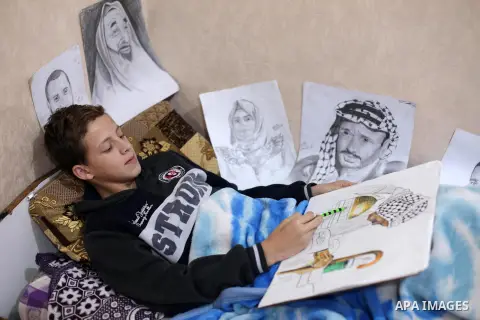A Palestinian painter Majd al-Madhoun, 13, who was wounded by Israeli army in the head on November 19, during a demonstration against the Israeli blockade on Gaza Strip, along the Gaza sea barrier on the maritime border...
