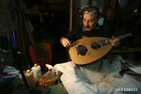 Palestinian nurse, Ali Hassanin, 57, who makes lutes, known in Arabic as an "Oud", works on a musical instrument, at his workshop, in the West Bank city of Nablus on November 26, 2018. Photo by Shadi Jarar'ah