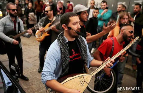 Palestinian musical band play music at street during a street carnival in the West Bank city of Nablus on November 28, 2018. Photo by Shadi Jarar'ah