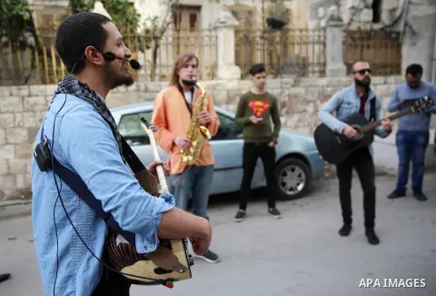 Palestinian musical band play music at street during a street carnival in the West Bank city of Nablus on November 28, 2018. Photo by Shadi Jarar'ah