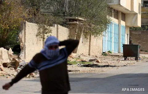 Palestinian protesters hurl stones towards Israeli forces during clashes following a weekly demonstration against the expropriation of Palestinian land by Israel in the village of Kfar Qaddum, near the West Bank city of...