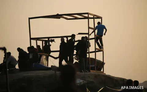 Palestinian protesters gather during clashes with Israeli troops in tents protest where Palestinians demand the right to return to their homeland at the Israel-Gaza border, in east of Gaza City on November 30, 2018. Phot...