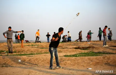 Palestinian protesters gather during clashes with Israeli troops in tents protest where Palestinians demand the right to return to their homeland at the Israel-Gaza border, in east of Gaza City on November 30, 2018. Phot...