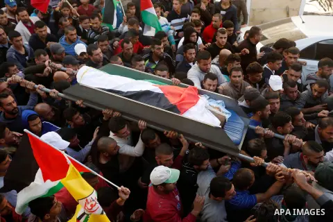 Mourners carry the body of 27-year-old Palestinian man Omar Awad who was shot dead by Israeli forces after he allegedly attempted a car-ramming attack near a checkpoint during his funeral in Hebron in the occupied West B...