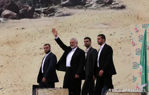 Chairman of the political bureau of the Hamas Palestinian Islamist movement, Ismail Haniyeh waves during a rally marking the 31th anniversary of the founding of the Hamas movement, in Gaza city, December 16, 2018. Photo...