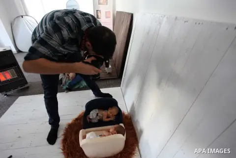 Yahya Barzaq, 28, a Palestinian photographer takes a photo during a new born baby photo session at his studio in Gaza city, December 17, 2018. Photo by Mahmoud Ajjour