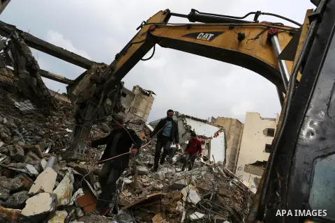 Palestinians walk on the rubbles of Al-Aqsa channel belonging to Hamas movement, that was destroyed by Israeli air forces in Gaza City, Gaza Strip, December 20, 2018. A Hamas-affiliated TV station which had its studios d...