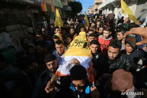 Mourners carry the body of Palestinian Ayman Shbeir, 18, who was shot dead by Israeli forces during clashes with Israeli troops in tents protest where Palestinians demand the right to return to their homeland at the Isra...
