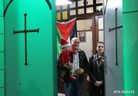 Palestinian Christians attend a prayer at the latin church on the eve of the Christmas celebration, in Gaza city on December 24, 2018. Photo by Ashraf Amra