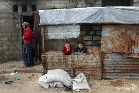 Palestinian children pose for a photo during a rainy day at Nahr al-Bared refugee camp in Khan Younis in the southern Gaza Strip on December 30, 2018. Photo by Ashraf Amra