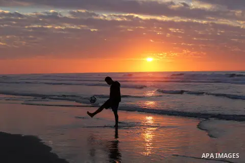 Palestinians enjoy their time on the beach during sunset in the last day of 2018, a few hours prior to the new year's celebrations, in Gaza city on December 31, 2018. Photo by Ashraf Amra