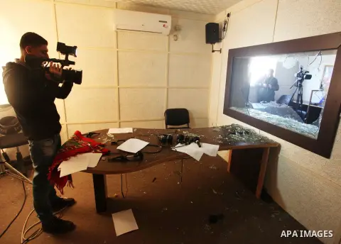 Employees of the Palestinian government-run radio and television stations inspect the damage at their offices on January 4, 2019. Five armed men entered the offices of Palestine TV and the Voice of Palestine radio statio...