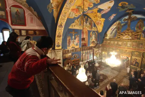 Palestinian Greek Orthodox Christians attend Christmas mass at the Orthodox Saint Porfirios church in Gaza City on January 7, 2019. The Orthodox Church celebrates Christmas and other religious holidays according to the J...