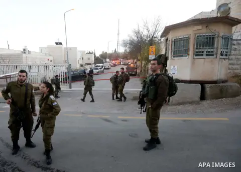 Israeli forces gather at a scene of an alleged stabbing attack at the entrance of Kiryat Arba settlement in the West Bank city of Hebron, 11 January 2019. According to reports, Israeli forces shot and killed a Palestinia...