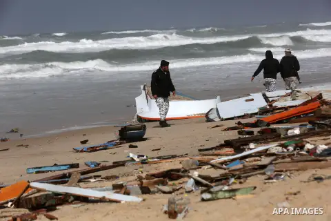 Members of Palestinian security forces inspect the remains of an Egyptian fishermen's boat, which was destroyed during a winter storm off the beach of the central Gaza Strip, January 17, 2019. Photo by Ashraf Amra
