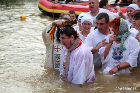 Orthodox Christian pilgrims perform baptisms at Qasr al-Yahud baptism site on the Jordan River, during the Epiphany Day, near the West Bank city of Jericho, 18 January 2019. The ritual takes place at the site which is be...