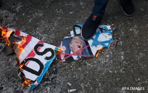 Palestinians burn an Israeli, British and U.S. flags during a protest to show solidarity with Palestinian prisoners held in Israeli jails, in front of Red cross office in Gaza city, on January 21, 2019. Photo by Mahmoud...