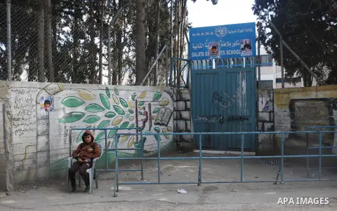 A Palestinian student sits in front of a (UNRWA) school, at Balata Refugee camp, near the West Bank city of Nablus, February 2, 2019. The Commissioner-General of the United Nations Relief and Works Agency for Palestine R...